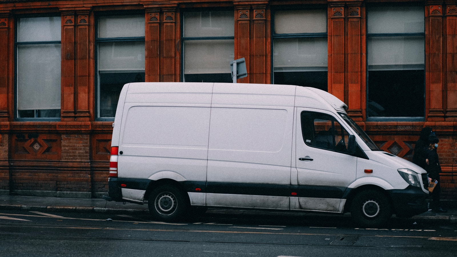 A clean white work truck on the road